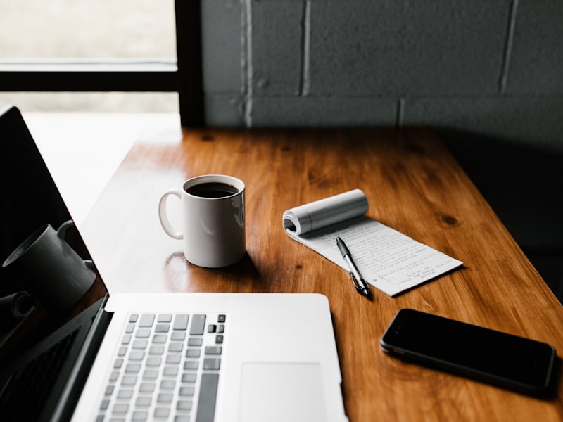 A tidy desk with laptop and coffee